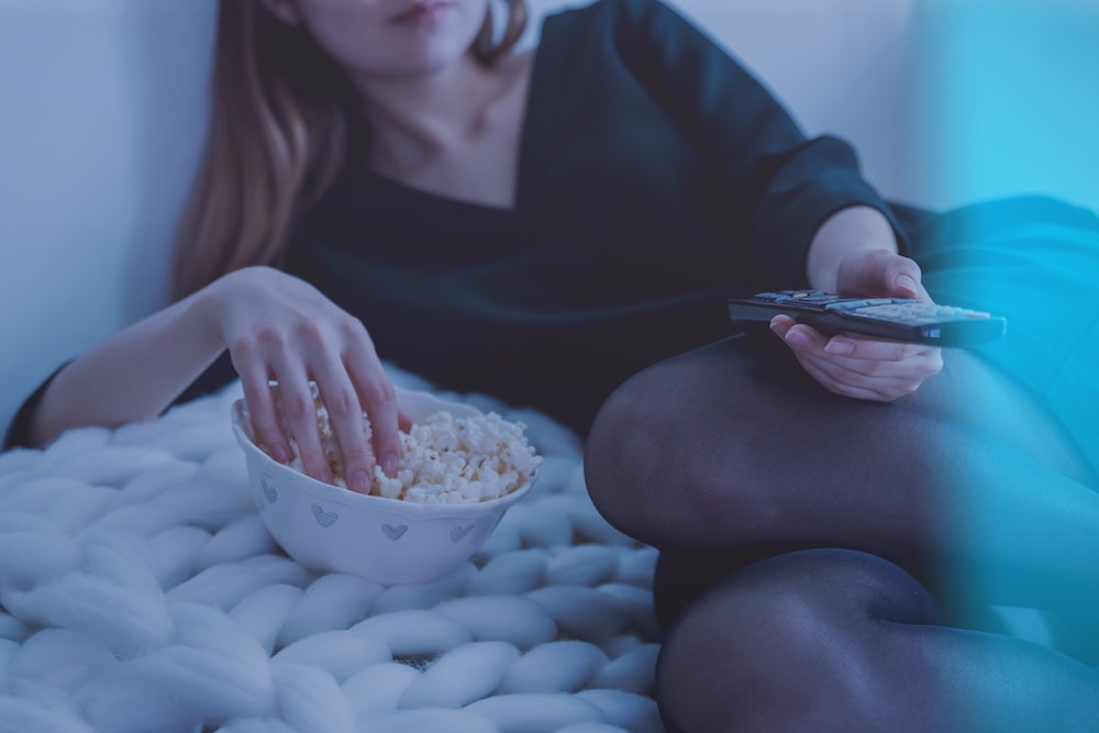 woman eating popcorn watching tv verygoodme.com